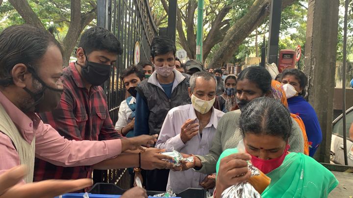 Chirag Indians volunteers distributing food packets to patients and families outside NIMHANS, Bengaluru