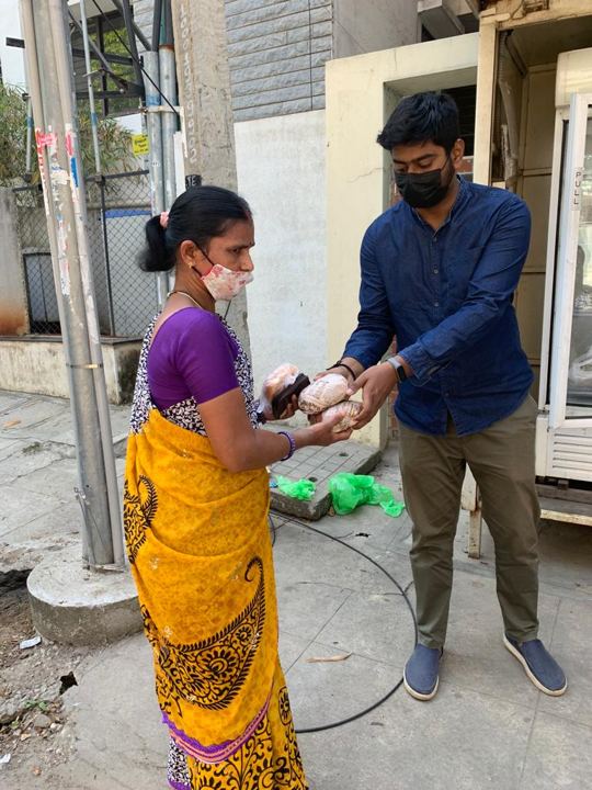 Volunteers handing out food from a public community fridge
