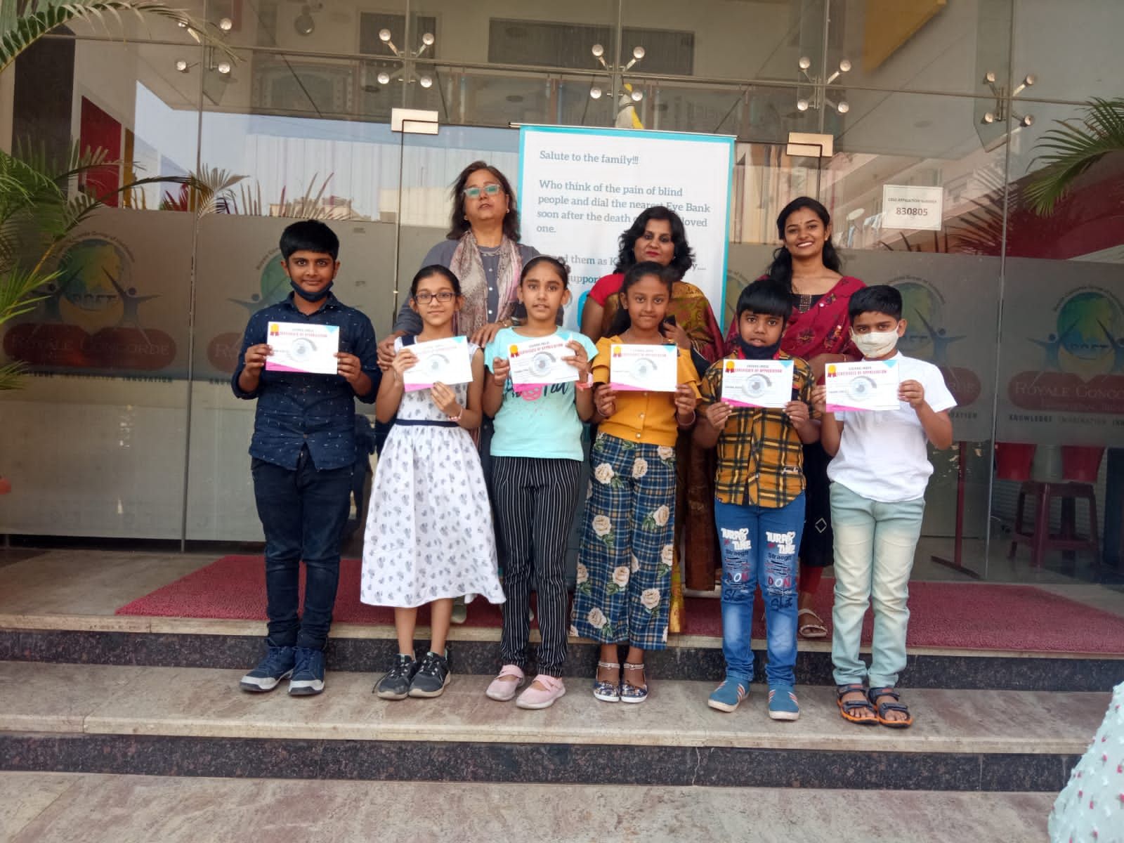 School children holding their eye donation pledge certificates at a Chirag Indians awareness event
