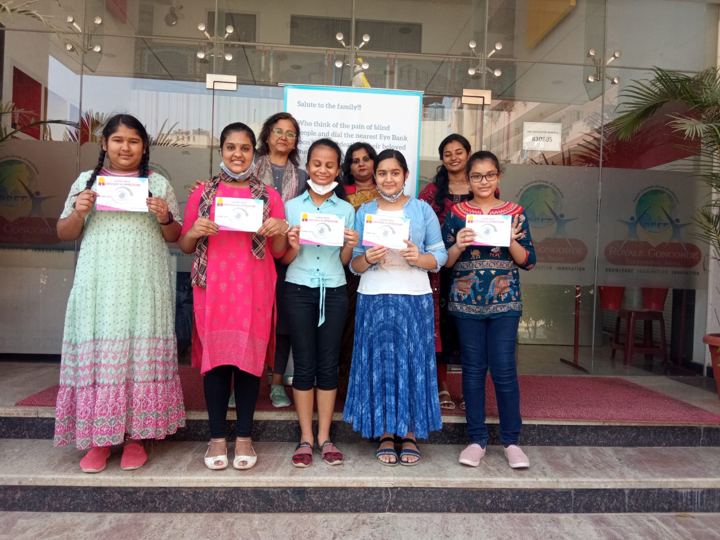 Students receiving certificates for pledging their eyes at a school awareness event