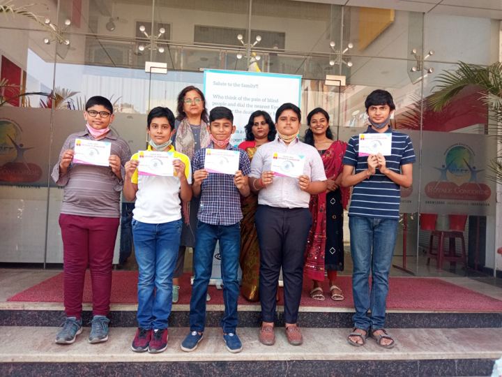 Students receiving certificates for pledging their eyes at a school awareness event
