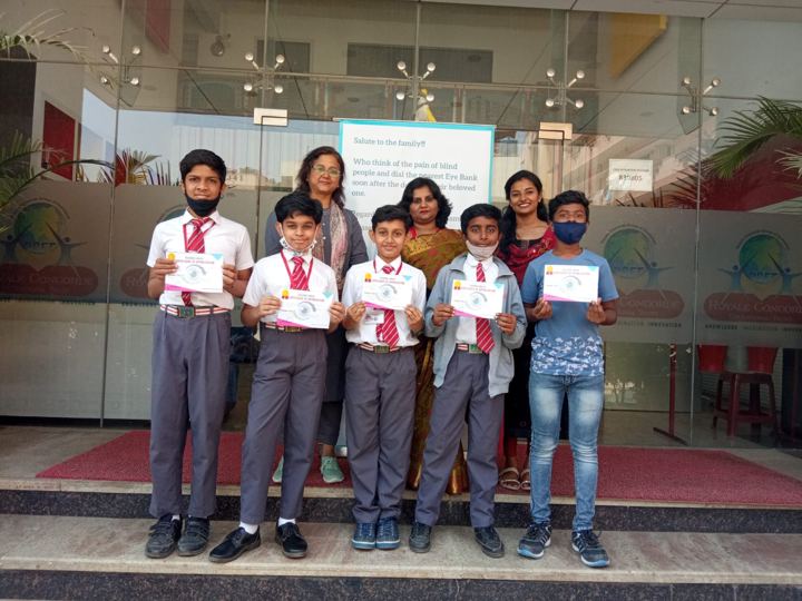 Students receiving certificates for pledging their eyes at a school awareness event