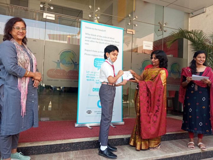 Students receiving certificates for pledging their eyes at a school awareness event