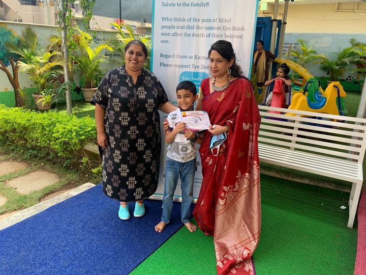 Students receiving certificates for pledging their eyes at a school awareness event