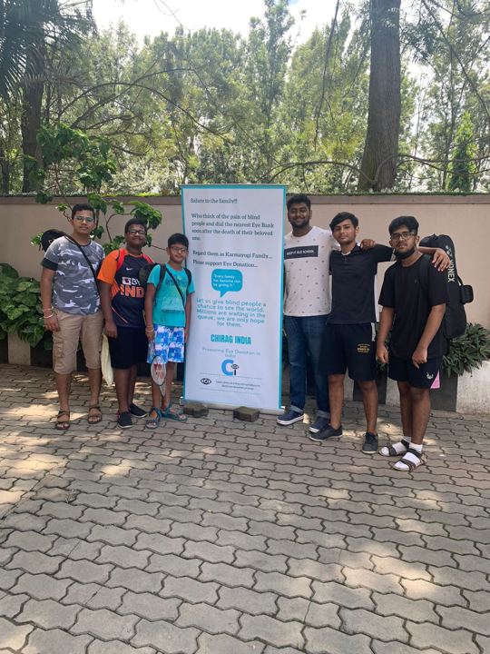 Volunteers setting up a Chirag Indians standee in an apartment complex