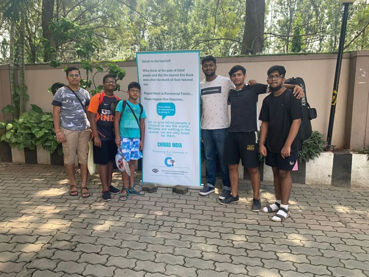 Volunteers setting up a Chirag Indians standee in an apartment complex
